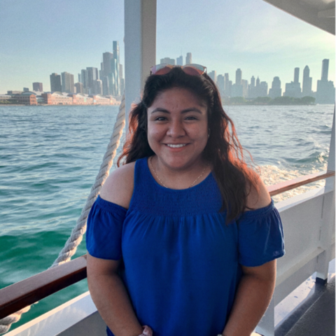 McKrina Lopez standing on a boat with a city skyline in the background