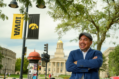 Jorge Guerra standing in downtown Iowa City with the Old Capitol in the background