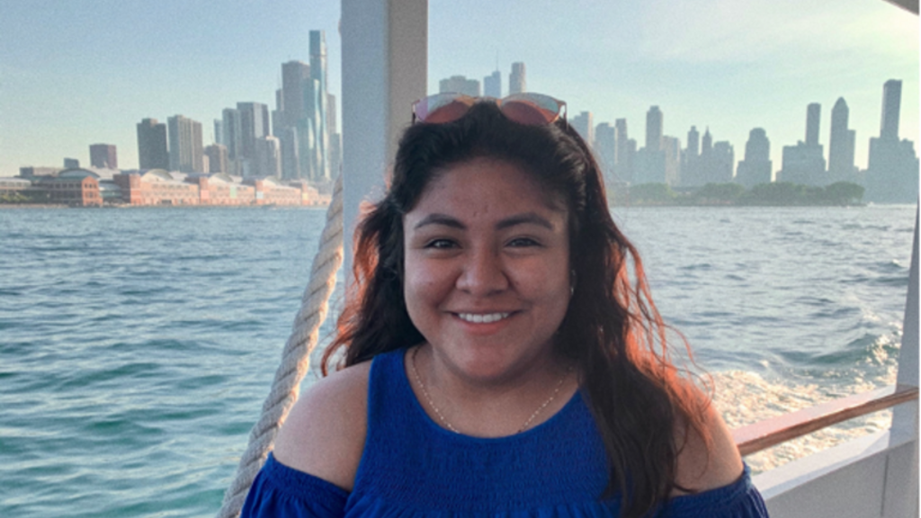 McKrina Lopez standing on a boat with a city skyline in the background