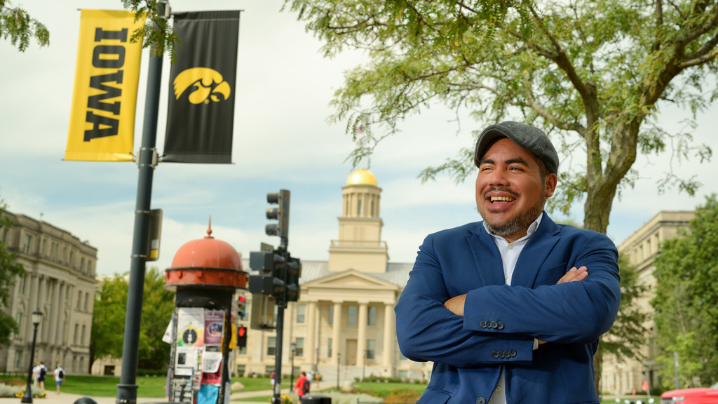 Jorge Guerra standing in downtown Iowa City with the Old Capitol in the background
